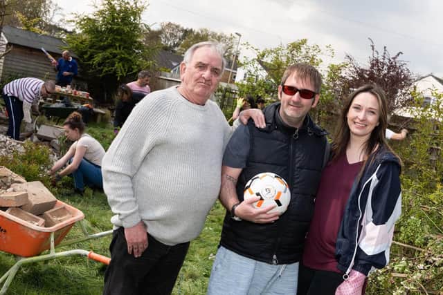Ricky's (centre) with his father (L) and fiancee Clarissa Knight (R). Ricky is holding a 'blind' football donated by Sheffield Co. Goalfix. It is Ricky's dream to be able to play football with his son George in the garden. Picture: Duncan Shepherd