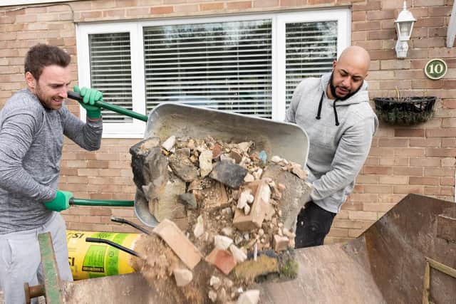 Rubble from inside the house has stacked up in his garden and his partner is calling on the community to help shift it so Ricky can enjoy the space with their three-year-old boy, George, and make up for lost time this summer. Picture: Duncan Shepherd.