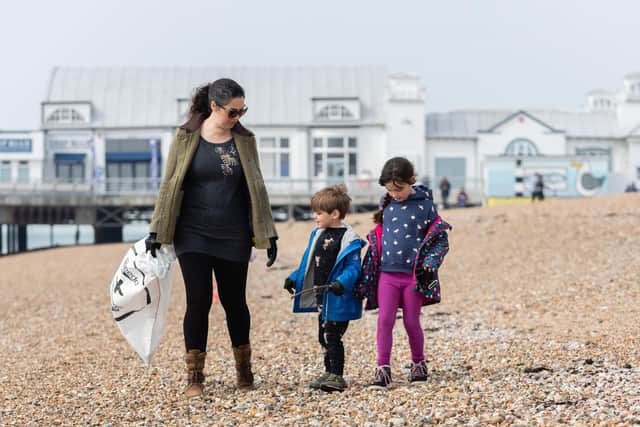 Big Spring Beach Clean - Abigail Fisher from Milton with her children Alexander (age 4) and Isabella (age 6) looking for rubbish on the beach. (060419-013)