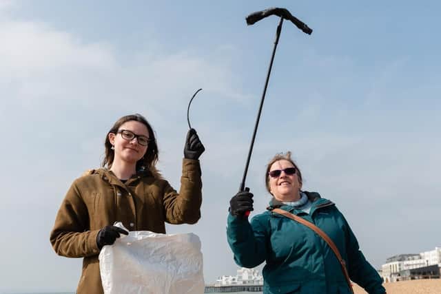 Big Spring Beach Clean - Leigh-Marie Hobday and Colleen Beattie hold up some of their finds. (060419-009)