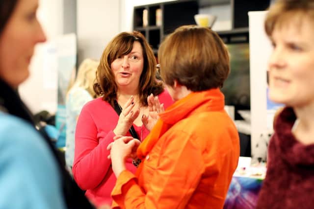 Juliette Willsteed, in pink, of Lake Therapies. Eco Fair, The Village Hotel, Lakeshore Drive, Portsmouth. Picture: Chris Moorhouse. (240319-19)