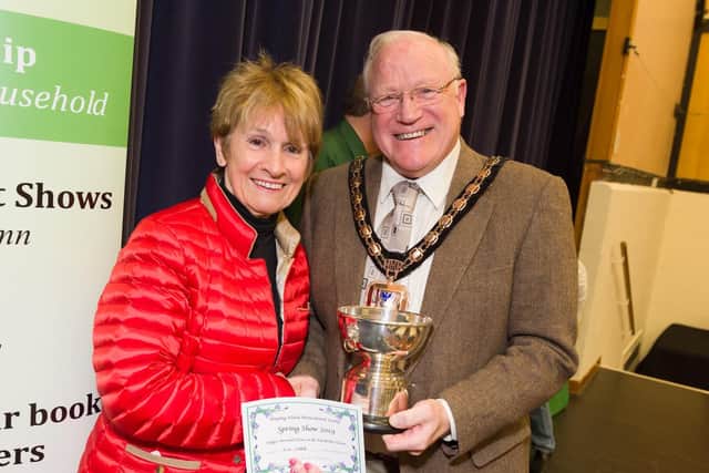 The Hayling Island Horticultural Society has more than 800 numbers and is gearing up to put on its Spring Show for 2019.  Members create floral displays  enjoyed by visitors, and judged by Cllr Peter Wade, Mayor of Havant - Cllr Wade presents Iris Cottle with the Tibble Trophy for her Floral Art. Picture: Duncan Shepherd