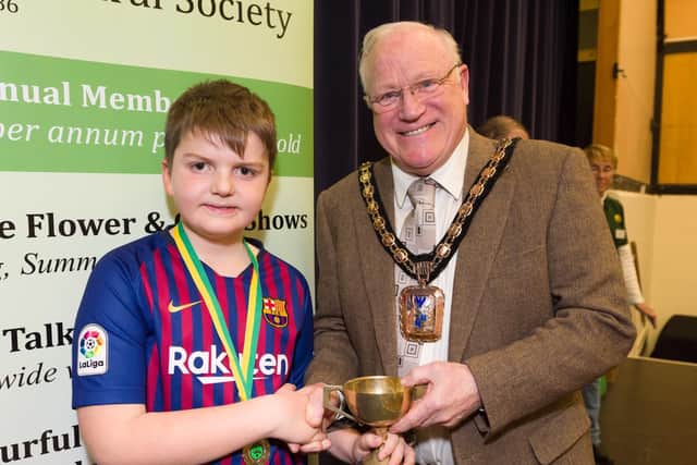 The Hayling Island Horticultural Society has more than 800 numbers and is gearing up to put on its Spring Show for 2019.  Members create floral displays  enjoyed by visitors, and judged by Cllr Peter Wade, Mayor of Havant - Toby Pyatt is awarded the Davies Cup for the most points in the Junior classes. Picture: Duncan Shepherd