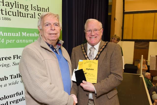 The Hayling Island Horticultural Society has more than 800 numbers and is gearing up to put on its Spring Show for 2019.  Members create floral displays  enjoyed by visitors, and judged by Cllr Peter Wade, Mayor of Havant - Cllr Wade congratulates Mark Ward on his prize winning daffodils. Picture: Duncan Shepherd
