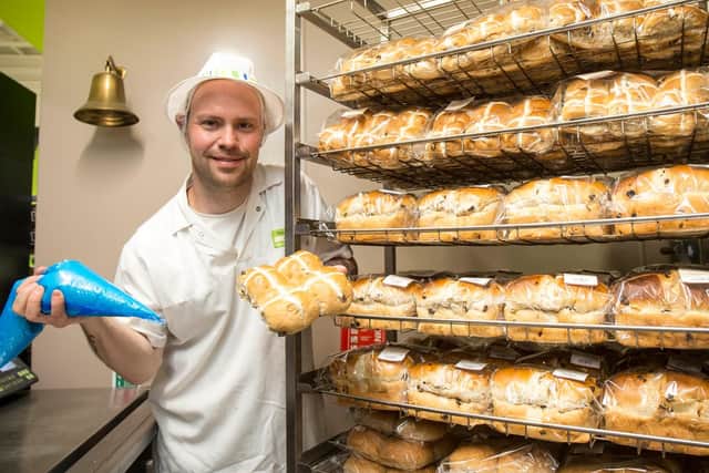 Carl has eight-years experience putting the crosses on hot cross buns. Picture: Robin Jones