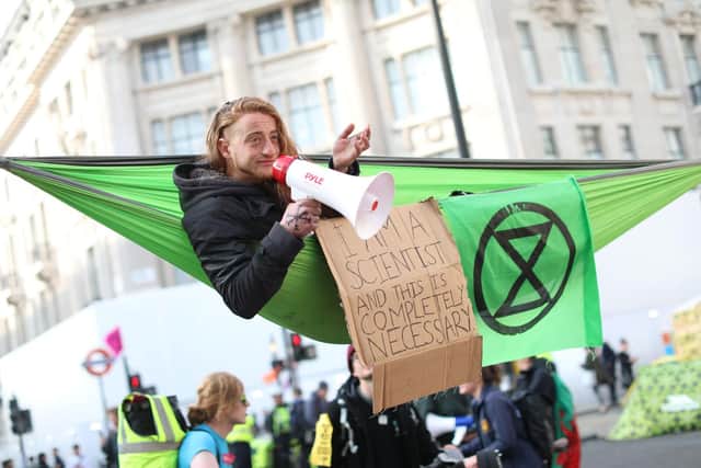 A climate change activist in a hammock in Oxford Circus as part of the protest by the Extinction Rebellion group. Picture: Isabel Infantes AFP/Getty Images