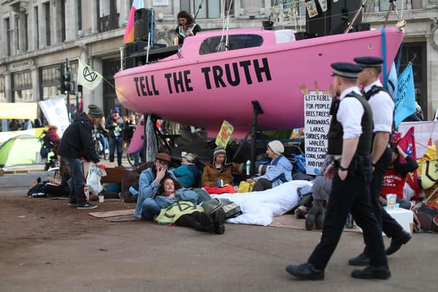 Police officers patrol by climate change activists occupying Oxford Circus. Picture: Isabel Infantes AFP/Getty Images