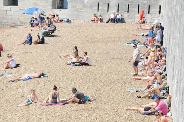 Many people enjoyed warm weather down at the Hot Walls, Old Portsmouth, on Friday, April 19. Picture: (190419-5470)