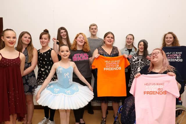 Performers including Megan Wilson holding up their Friend Finder t-shirts at a concert in aid of the charity at the Springwood Community Centre in Waterlooville. Picture: Chris Moorhouse (300319-35)