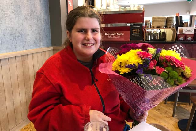 Megan Wilson with the bouquet of flowers given to her by Emma and Lewis Hine
