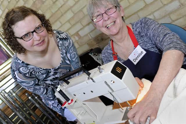 Emma Bentley, left, gives Denise Taylor a curtain to fix. Picture: Ian Hargreaves  (200419-3)