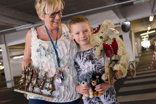 For the third consecutive year, Tesco Fratton Park Extra held its annual Easter Sunday car boot. Pictures is Jo Cassey and Kye Crasswell with some of their purchases. 
Picture: Duncan Shepherd