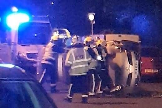 The Nissan Micra on its side in New Road, Copnor, on Sunday night