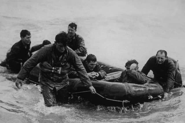 Survivors Ashore 6th June 1944:  Survivors from a landing craft which sank off Omaha Beach, Normandy, come safely ashore on a life raft.  (Photo by Weintraub/Keystone/Getty Images)