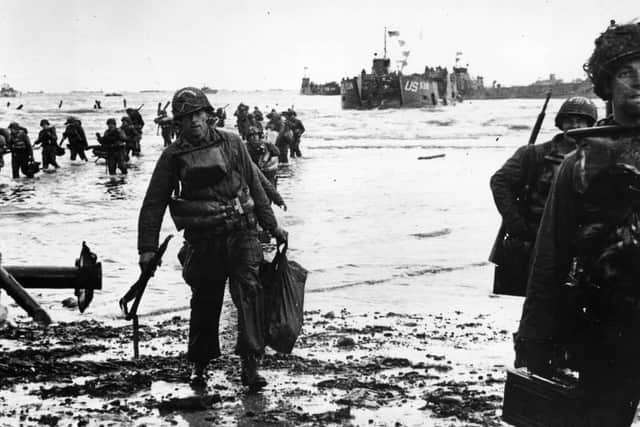 6th June 1944:  American assault troops wading ashore on Omaha beachhead in Normandy.  (Photo by Fox Photos/Getty Images)