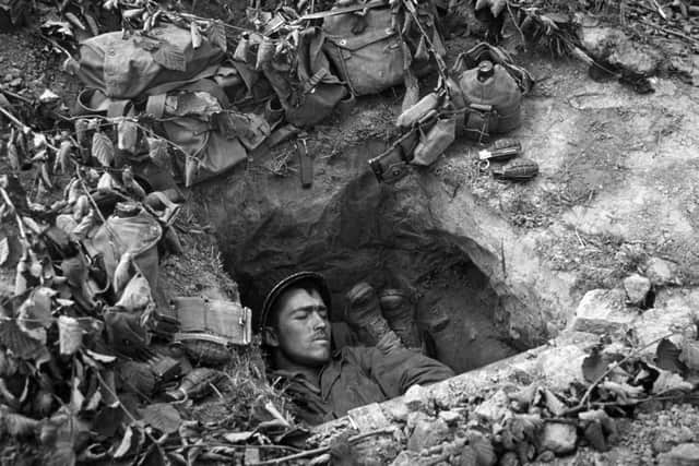 Asleep In A Trench 1944: An American GI asleep in a trench in Normandy.   (Photo by Three Lions/Getty Images)