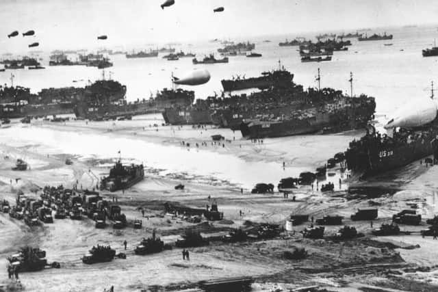 Normandy Beachhead 14th July 1944:  Fleets of US transport and landing craft disgorge reinforcements and supplies for the US troops who liberated the Contentin peninsula, the deep-water port of Cherbourg and the communication centre of La Haye du Puits. Barrage balloons float overhead as protection against German strafing aeroplanes, which did not appear.  (Photo by Keystone/Getty Images)