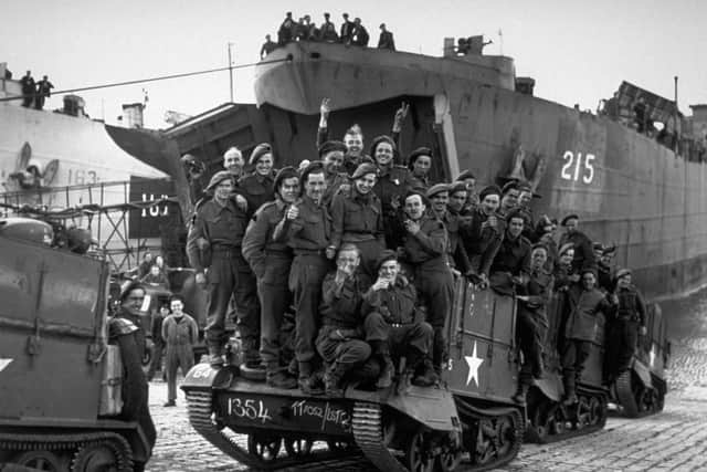 Normandy Troops 14th June 1944:  Reinforcements disembark from a landing craft, aboard a Bren Gun Carrier newly arrived in Normandy from Britain.  (Photo by Reg Speller/Fox Photos/Getty Images)