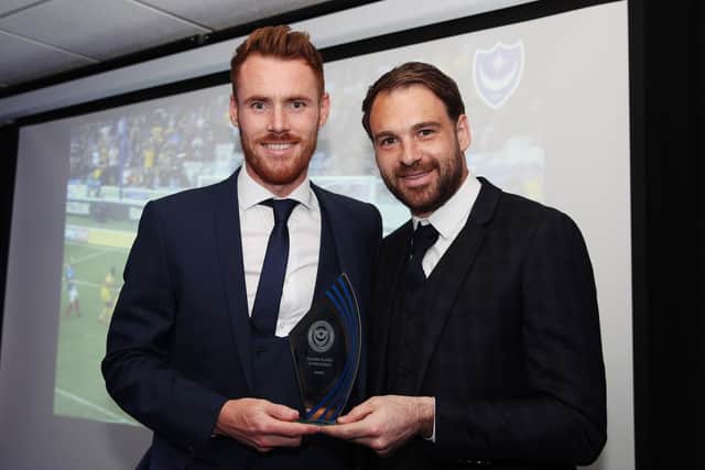 Tom Naylor (left) receives his award alongside Pompey skipper Brett Pitman
