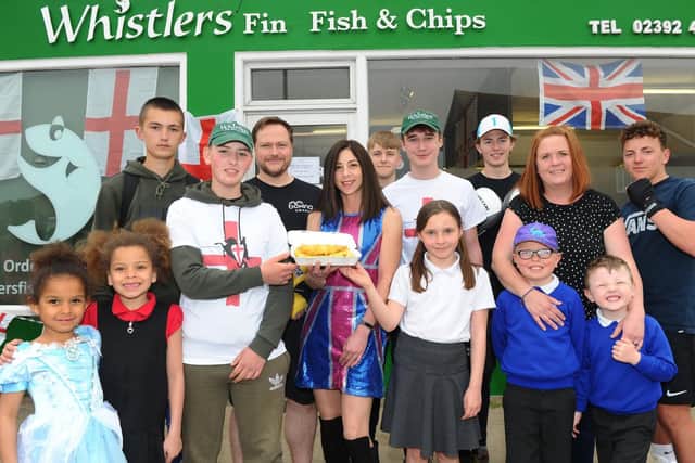 Pictured centre, Rana Denholm, co-owner of Whistler's Fish and Chip shop, with members from Hayling Hi-5 and and the Heart of Hayling Boxing Club. Picture: Sarah Standing (230419-6925)