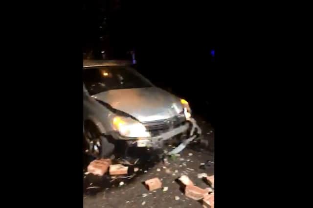 Still from a video showing a car that was crashed into a garden wall in Gosport