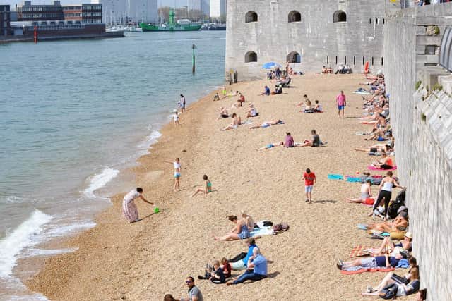 People enjoying the warm weather down at the Hot Walls, Old Portsmouth. Picture: Sarah Standing (190419-5465)