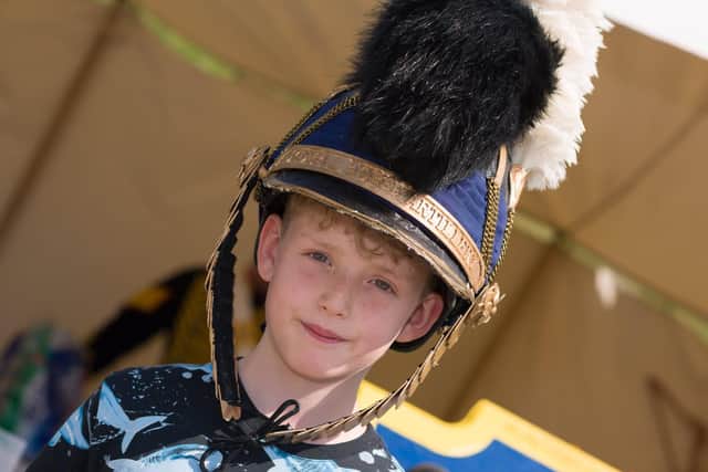 Seth Ord (9yrs) tries on period head gear from the Roya lHorse Artillary. Picture: Duncan Shepherd