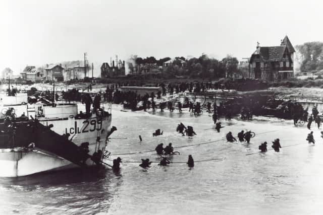 Allied troops pictured storming the Normandy beach off St Aubin, D Day, Second World War
