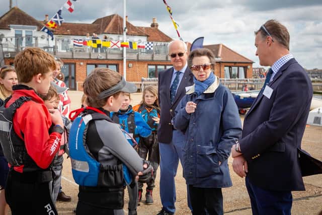 HRH The Princess Royal pictured with junior members, Michael Geary, Commodore (in glasses) and Tim Keeping Rear Commodore (right) during her visit to Emsworth Sailing Club today. The visit was arranged to help the club celebrate its centenary.