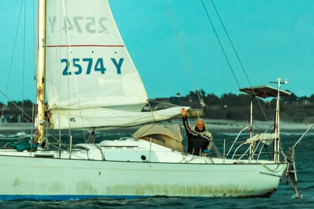 Anthony waves to friends and family after completing his solo non stop voyage around the world.