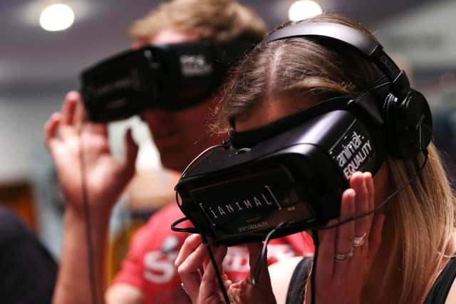 Terri Chandler tries a VR headset. Portsmouth Vegan Festival 2019, Portsmouth Guildhall. Picture: Chris Moorhouse (200419-19)