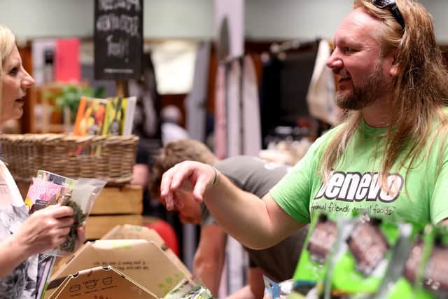 Wendy Brown listens to Damain Eadie of Benevo vegan pet foods. Portsmouth Vegan Festival 2019, Portsmouth Guildhall. Picture: Chris Moorhouse (200419-18)