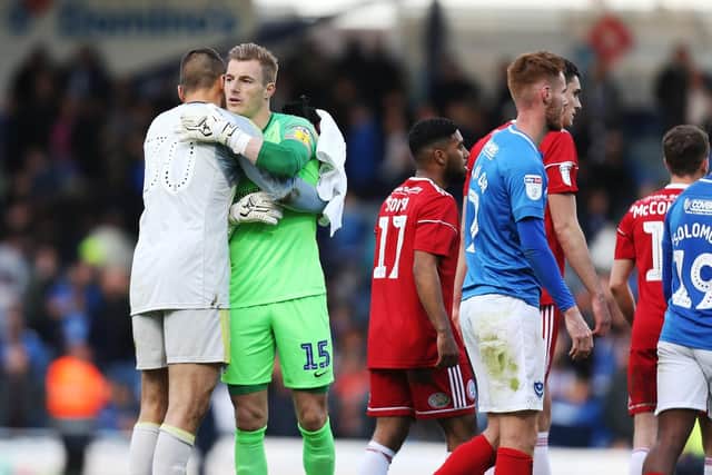 Pompey keeper Craig MacGillivray and Accrington stopper Dimitar Evtimov embrace after the 1-1 draw. Picture: Joe Pepler
