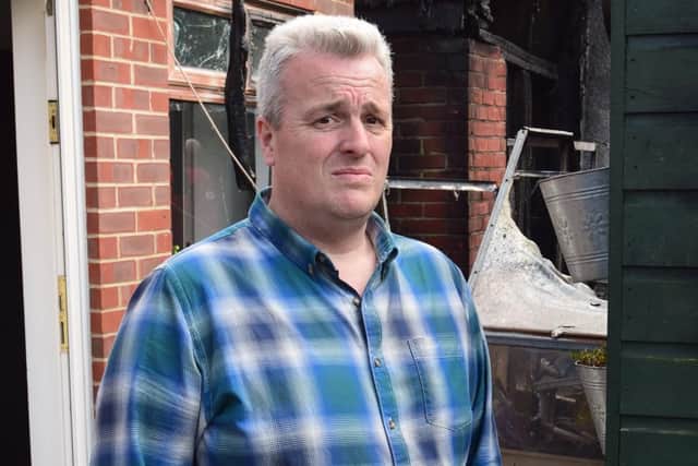 Andy Carpenter, 48, of Bedhampton, pictured by the remains of his shed after a blaze engulfed it. Photo: Tom Cotterill