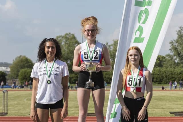 Sophie Brame on top of the podium with the cup which was one of four given by David Churcher, who is the senior womens team manager, attached to Chichester Runner & AC, to Hampshire Athletics for all female age groups for 200 metres. Picture: Paul Smith