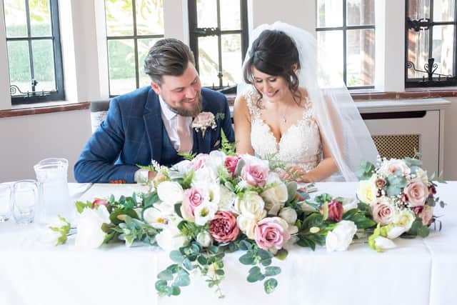 Vicki and Carl signing their marriage certificate. Picture: Carla Mortimer Photography