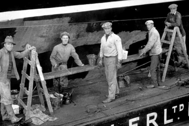 Dockyard men working on a barge. Can anyone date the photo or recognise the men? Picture: David Anderson collection.