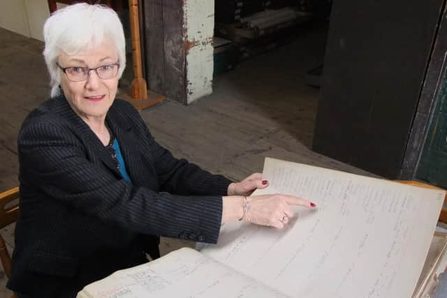 Cheryl Jewitt looking at her grandmother's name in the Rate Book. Picture: Portsmouth Royal Dockyard Historical Trust