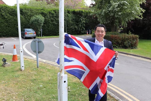 Havant MP Alan Mak with the Union Flag outside his office, in central Havant