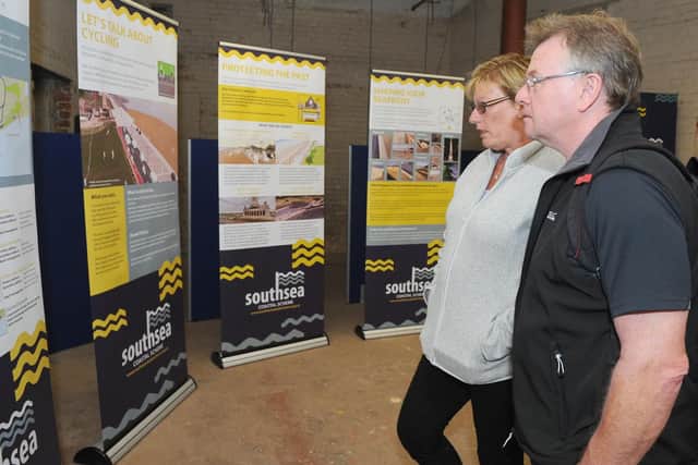Julie Thompson and John Luxford, from Eastney, look at the latest Southsea Coastal Scheme Plans at Monday's public drop-in session at Lumps Fort. Picture: Sarah Standing (270519-388)