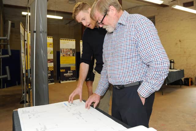 Robert Johnson, communication and engagement officer at Portsmouth City Council with Harry Allaway from Farlington, at the public drop-in session for the Southsea Coastal Scheme, at Lumps Fort, on Monday. Picture: Sarah Standing (270519-382)