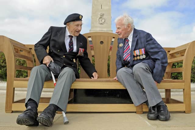 Ron Cross from Gosport, left, and Bob Jones, from Hayling Island, chat as they listen to tales of the D-Day on a new talking bench unveiled by the Commonwealth War Graves Commission. Picture; Ian Hargreaves (310519-4)