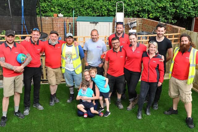 Standing in the middle, Kieran Cullen, project manager from WellChild with Katie Phillips and her twin boys (left) Charlie and Louis (4) and all the volunteers from Hilti.
Picture: Sarah Standing (300519-859)