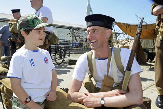D-Day event at Portsmouth Historic Dockyard. (l to r),  Ted Walker (seven), from Portsmouth with re-enactor Stephen Allnutt. Picture: Ian Hargreaves  (010619-6)
