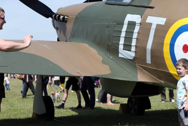 D-Day event at Stokes Bay, Gosport. Oliver Simmonds, 3, poses by a Hawker Hurricane for his father's photograph. Commemorative D-Day event at Stokes Bay highlighting the part that the borough of Gosport played in 1944. Picture: Chris Moorhouse (010619-40)