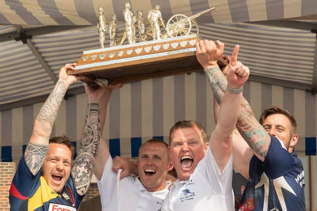 Team captains and No1 trainers from the REME and HMNB Portsmouth celebrate winning the Brickwood's Trophy in the competitions first ever tie. Picture Credit: Keith Woodland