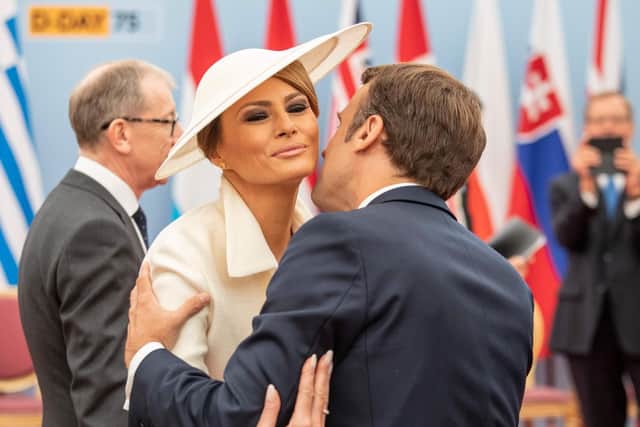French President Emmanuel Macron kisses US First Lady Melania Trump in greeting as they attend an event to commemorate the 75th anniversary of the D-Day landings, in Portsmouth. Picture: JACK HILL/AFP/Getty Images