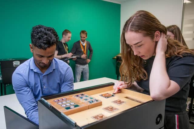 Puzzled: Mohammed Hassan and Annie Lewis trying to figure out the 'box'.

Picture: Habibur Rahman