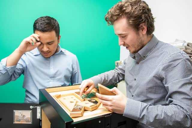 15/5/19CATCH LINE: Escape NewsroomSTORY: Escape rooms have come to the Portsmouth News office at Lakeside, challenging staff to escape from the Newsroom.Pictured: Puzzled: Mizanoor Rahman and Aiden Robinson trying to figure out the 'box'.Picture: Habibur Rahman