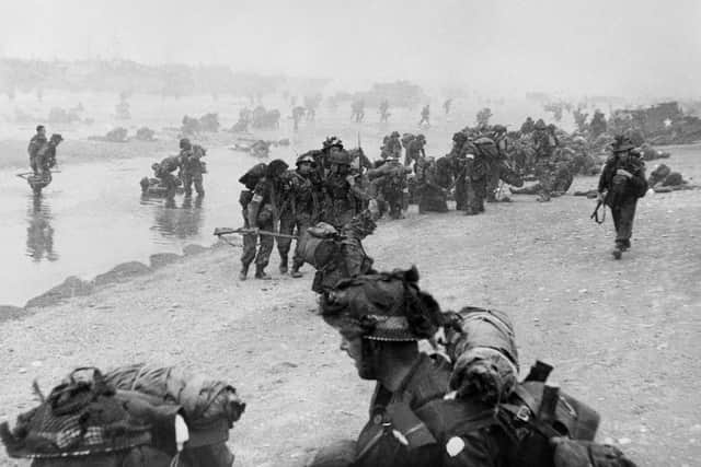 British troops take positions on Sword beach during D-Day 06 June 1944 after Allied forces stormed the Normandy beaches. D-Day, 06 June 1944 is still one of the world's most gut-wrenching and consequential battles, as the Allied landing in Normandy led to the liberation of France which marked the turning point in the Western theater of World War II. (Photo credit should read STR/AFP/Getty Images)
